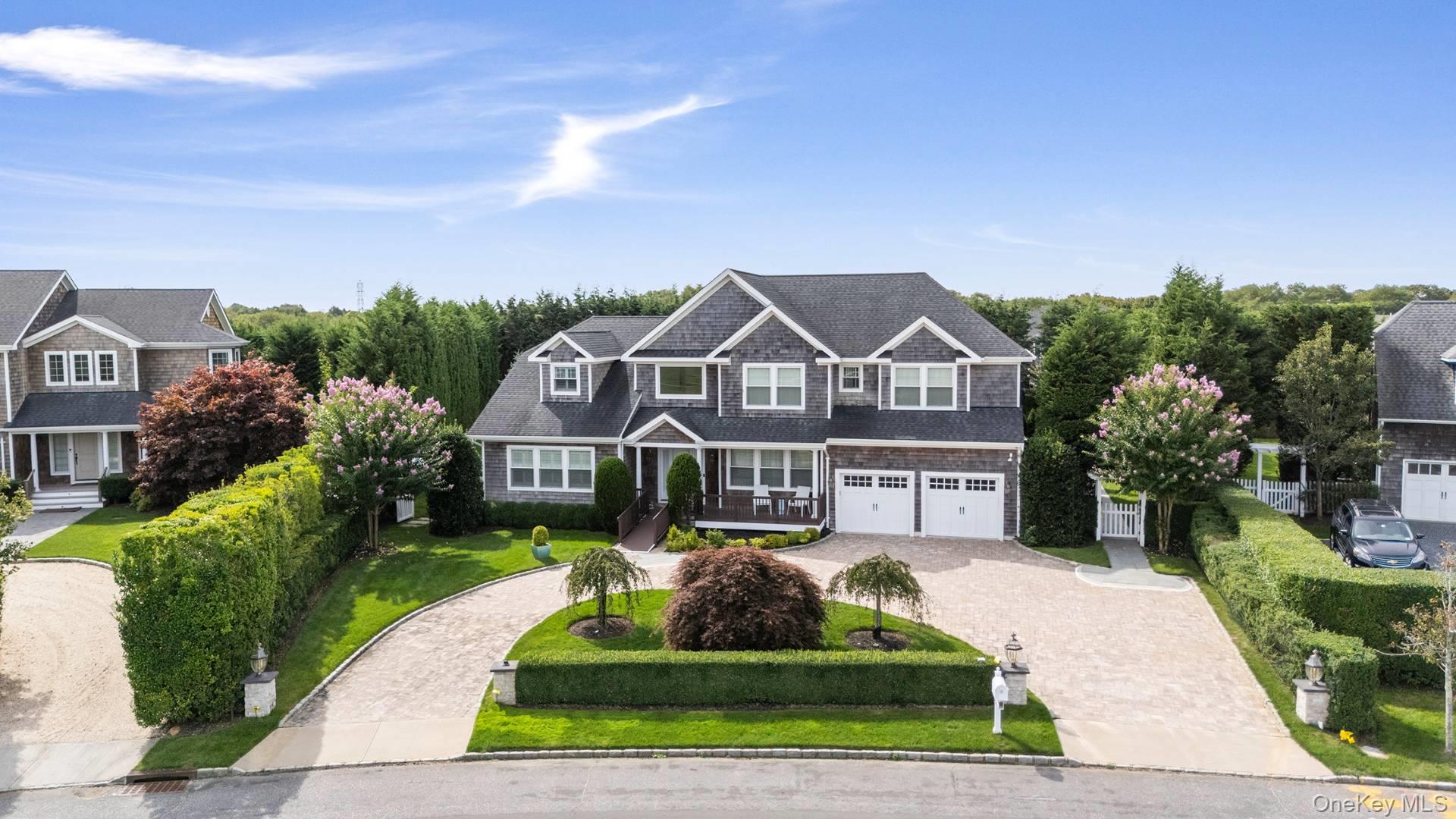 4 Spring Lane Southampton, NY 11968 - Photo 3 of 39 a front view of a house with a yard