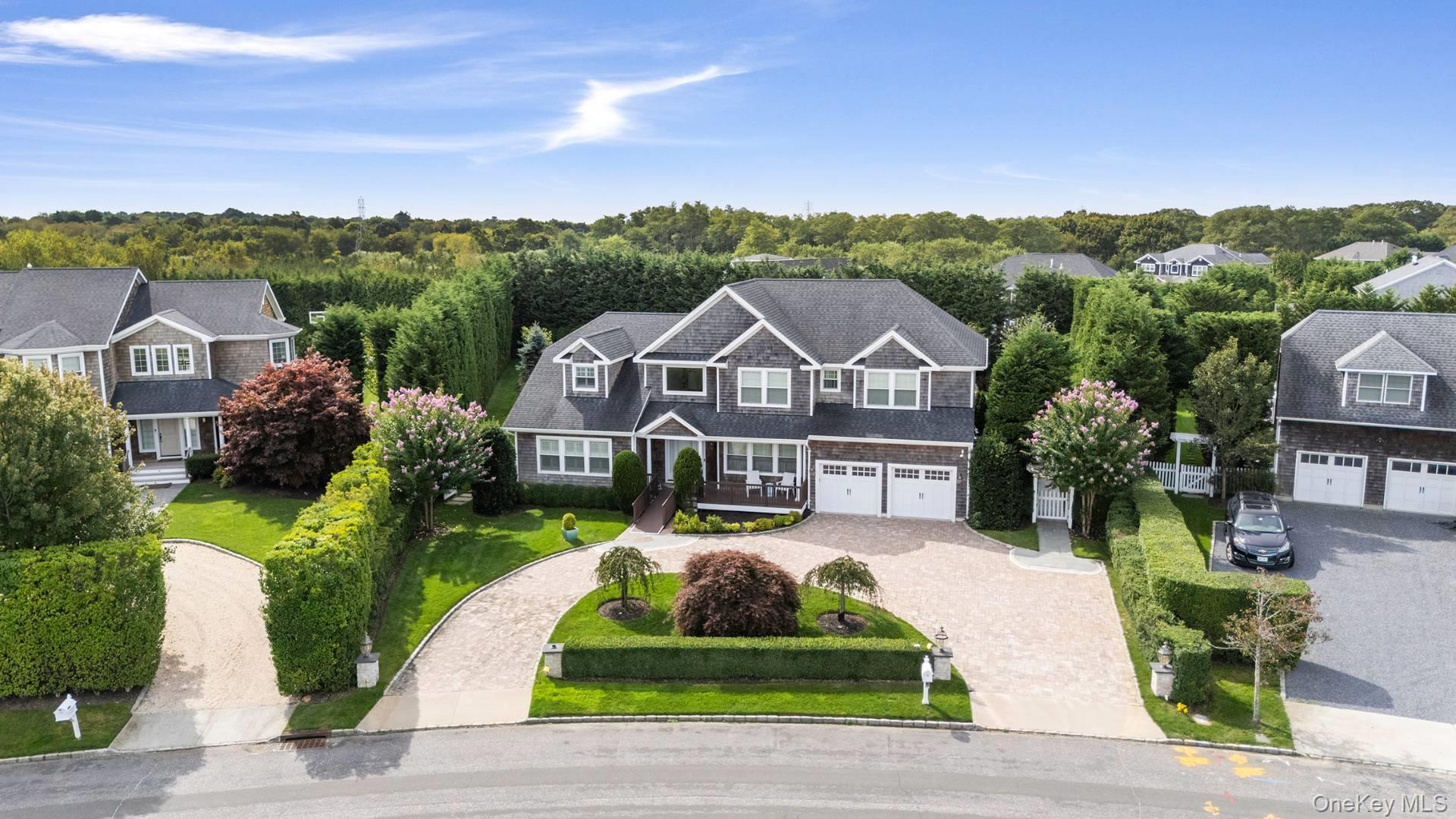 4 Spring Lane Southampton, NY 11968 - Photo 31 of 39 a front view of a house with a yard