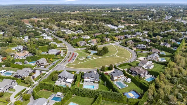an aerial view of residential houses with outdoor space and street view
