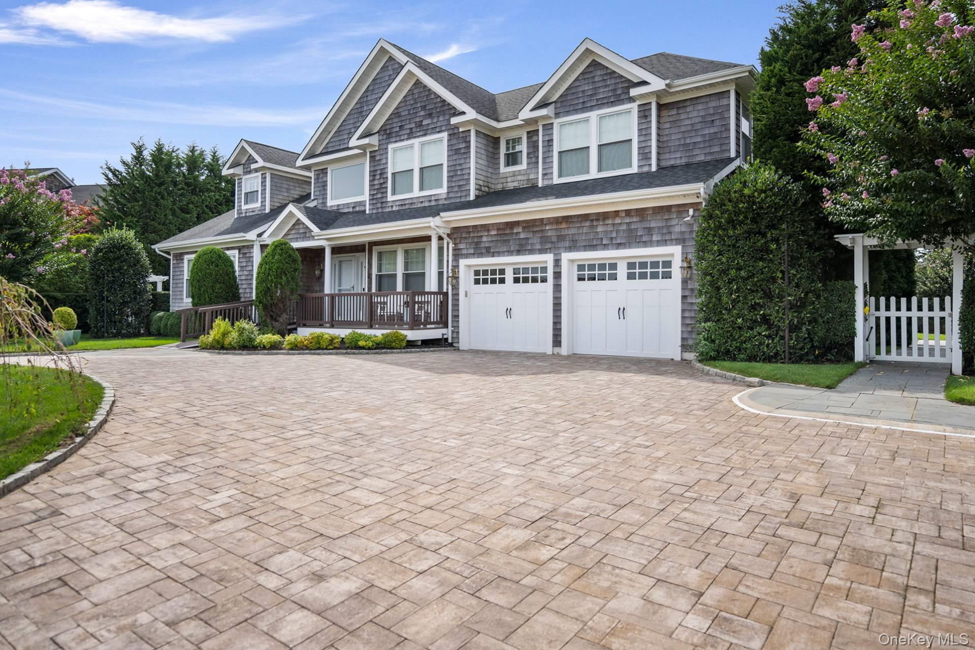 4 Spring Lane Southampton, NY 11968 - Photo 4 of 39 a view of a white house with a yard and plants
