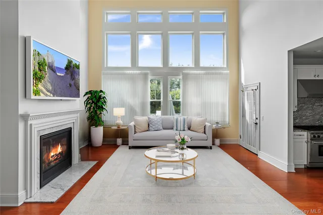 a living room with furniture a fireplace and a flat screen tv