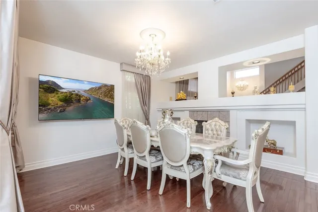 a view of a dining room with furniture wooden floor and chandelier