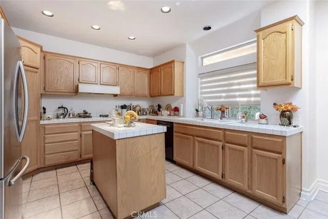 a kitchen with a sink window and cabinets