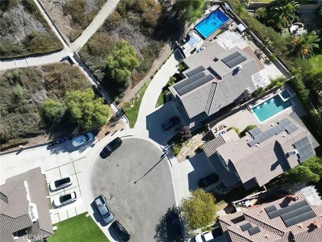 an aerial view of multiple houses with yard