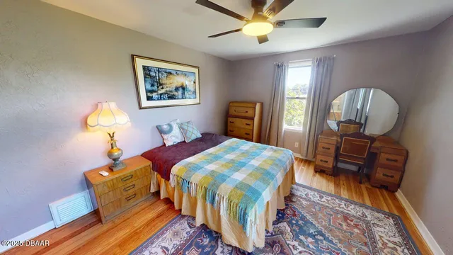 a bedroom with bed and wooden floor