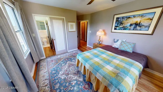 a bedroom with a bed and a painting on the wall