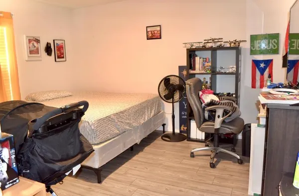 a view of a workspace with furniture and gym equipment