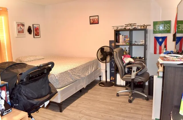 a view of a workspace with furniture and gym equipment