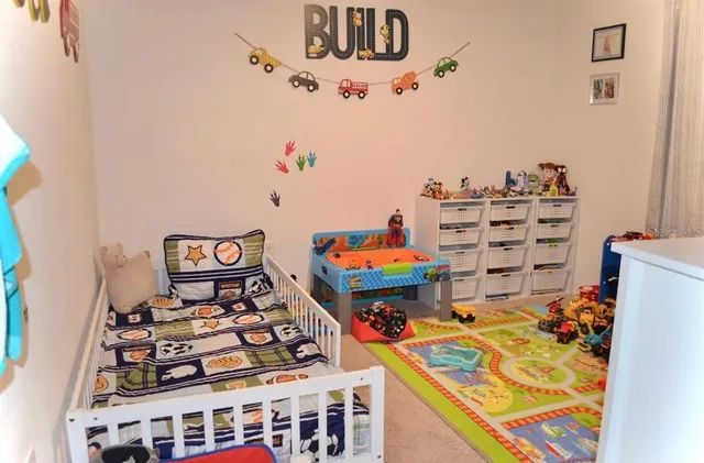 a kitchen with a refrigerator and a stove top oven
