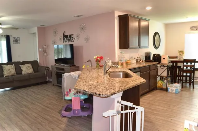 a kitchen with a kitchen island a stove and a wooden floors
