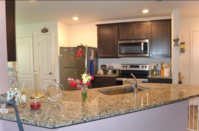 a kitchen with a refrigerator sink and microwave