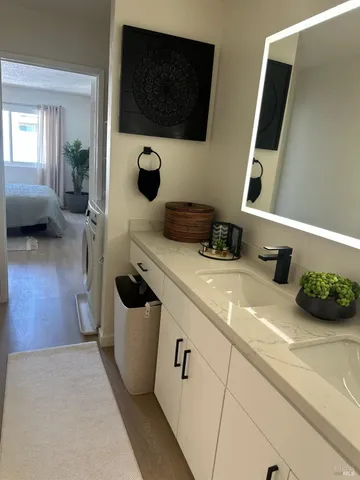 a bathroom with a sink a mirror and bathtub