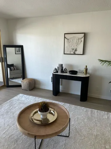 a living room with furniture and a lamp