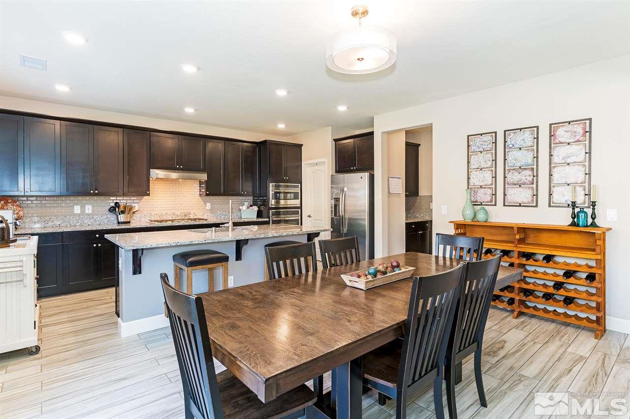 1650 Scott Valley Road Reno, NV 89523 - Photo 6 of 25 a kitchen with granite countertop a dining table chairs and refrigerator