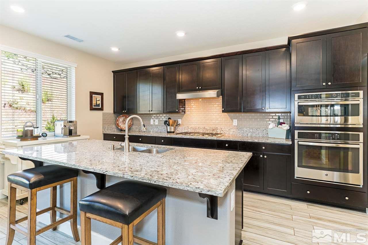 1650 Scott Valley Road Reno, NV 89523 - Photo 8 of 25 a kitchen with granite countertop stainless steel appliances and wooden cabinets