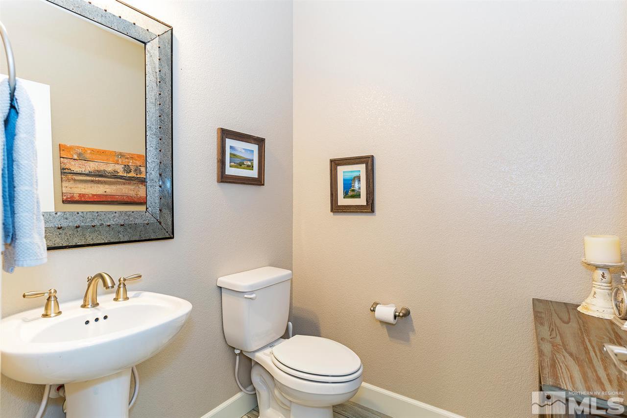 1650 Scott Valley Road Reno, NV 89523 - Photo 10 of 25 a bathroom with a toilet a sink and mirror