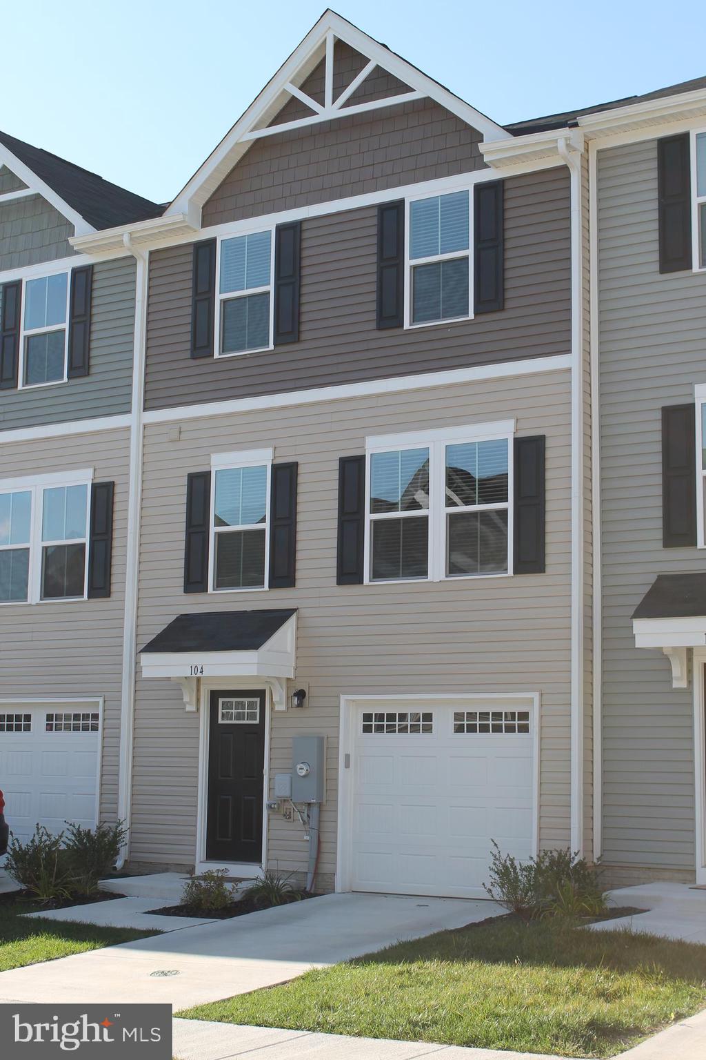 104 Reign Way Winchester, VA 22603 - Photo 2 of 27 a front view of a house with a yard and garage