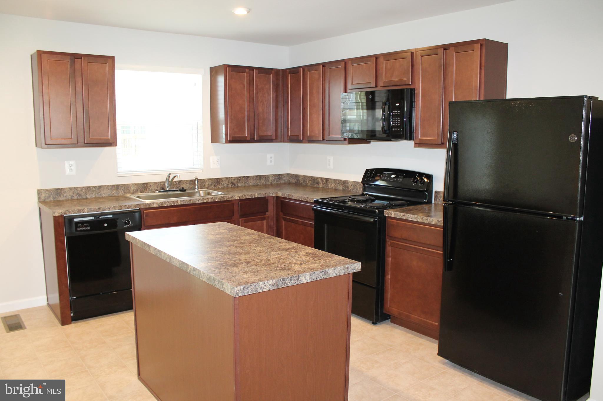 104 Reign Way Winchester, VA 22603 - Photo 7 of 27 a kitchen with a sink stove and refrigerator