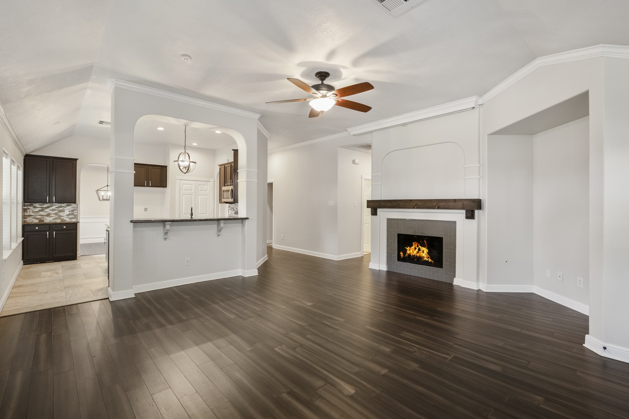 5802 Sawyer Bend Lane Spring, TX 77379 - Photo 16 of 50 a view of an empty room with wooden floor and a fireplace