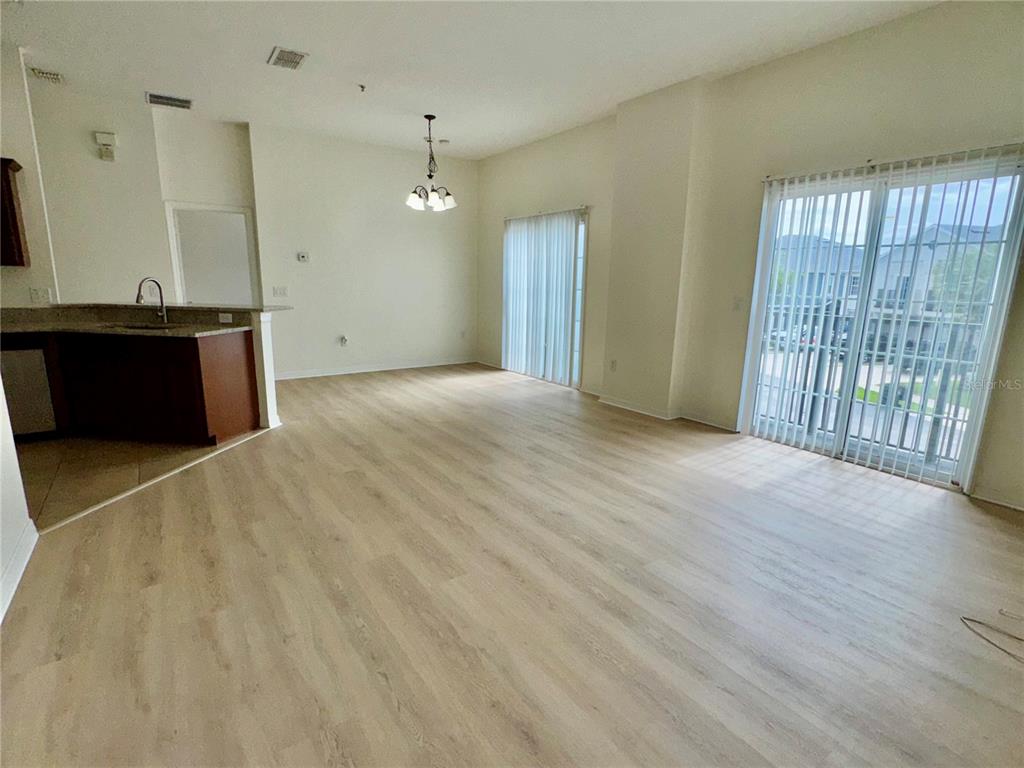 6404 South Goldenrod Road, Unit 2A Orlando, FL 32822 - Photo 24 of 40 wooden floor in an empty room with a window