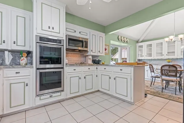 a kitchen with cabinets appliances and a sink