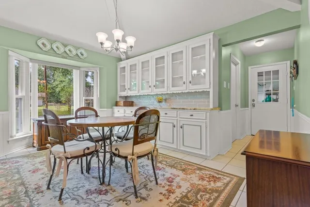 a dining room with furniture and window