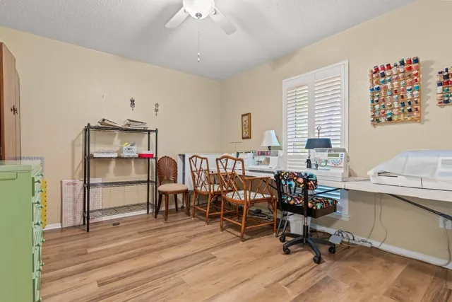 a view of a workspace with furniture and a window
