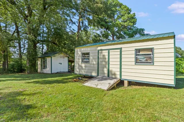 a backyard of a house with table and chairs