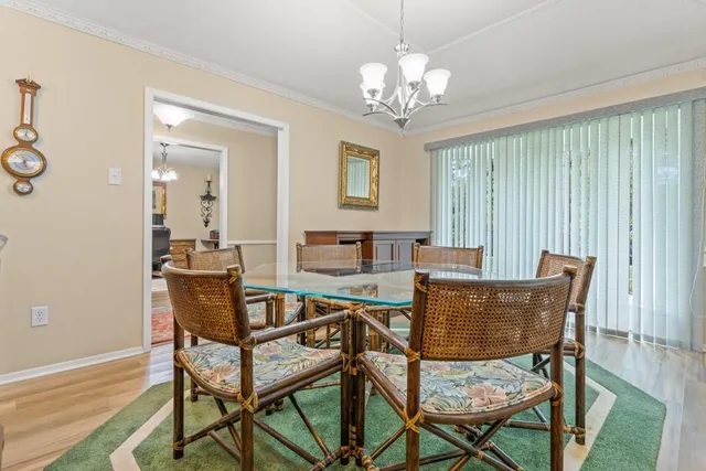 a view of a dining room with furniture and chandelier