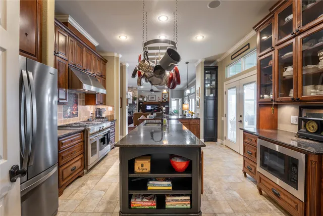 a kitchen with stainless steel appliances granite countertop a stove and a sink