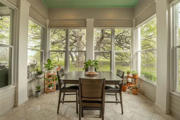 a dining room with furniture and window