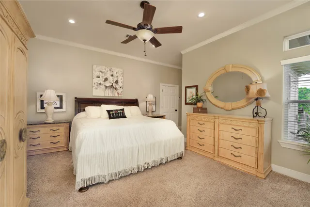 a bedroom with a bed a dresser and mirror