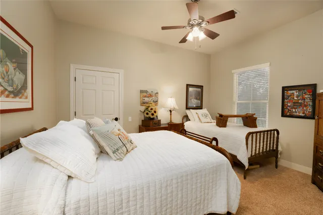 a bedroom with two beds and a chandelier