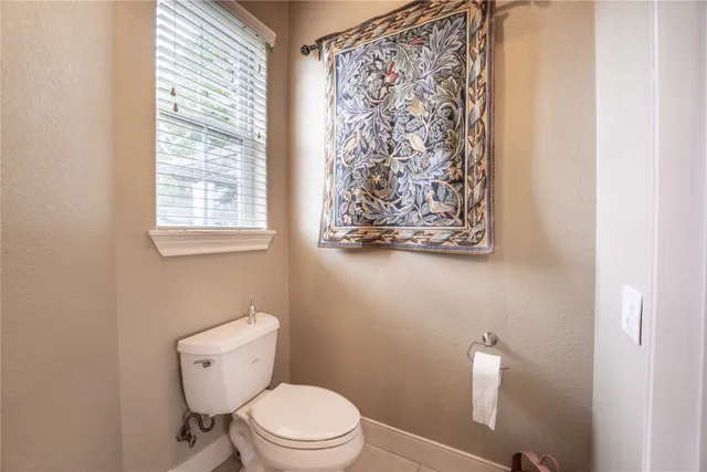 a white toilet sitting next to a bathroom sink