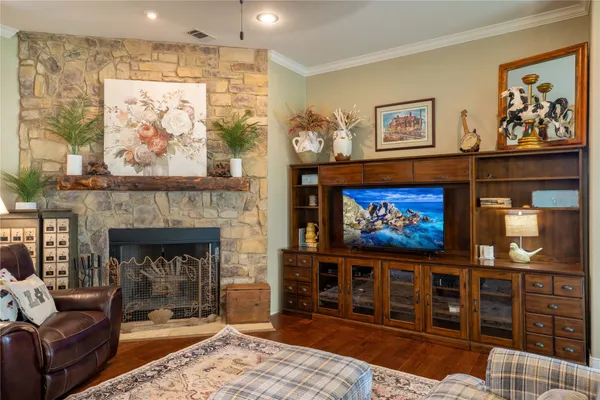 a living room with furniture a fireplace and wall paintings
