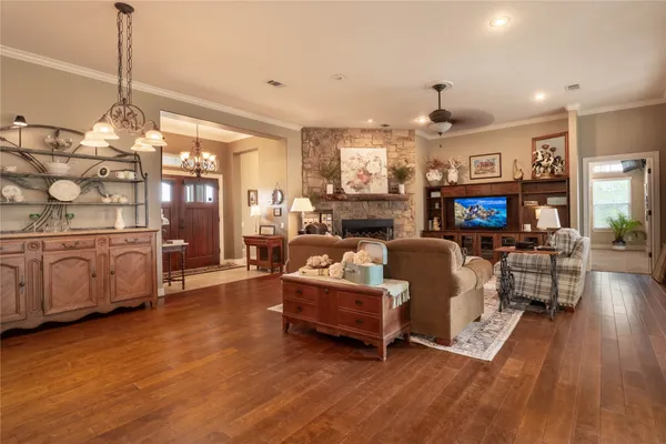 a living room with furniture and a chandelier