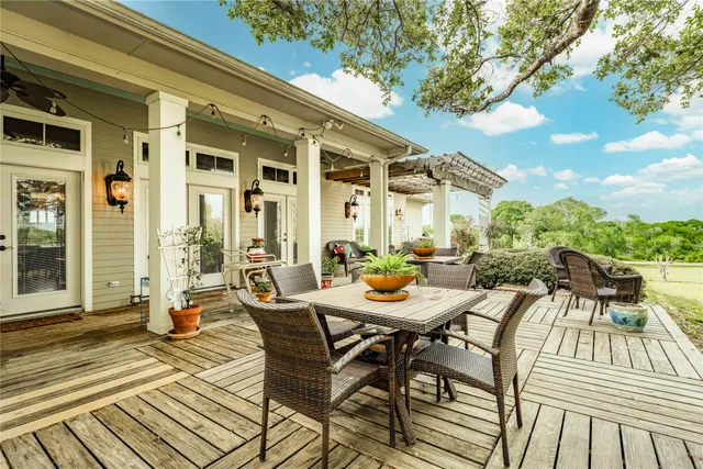 a view of a patio with table and chairs and potted plants