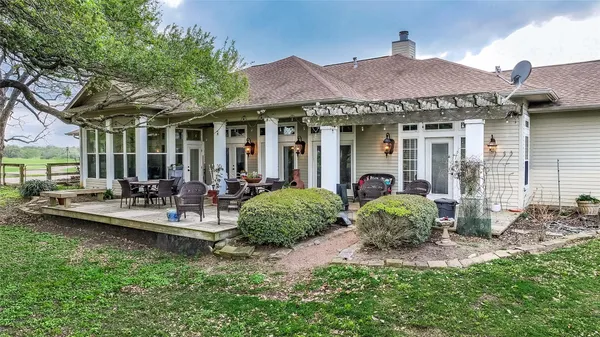 a view of a house with a chairs and table in a patio