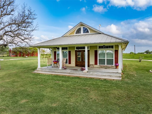 a front view of a house with a yard table and chairs