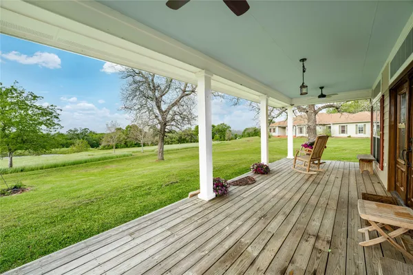 a kitchen with stainless steel appliances kitchen island granite countertop a table chairs in it and wooden floors