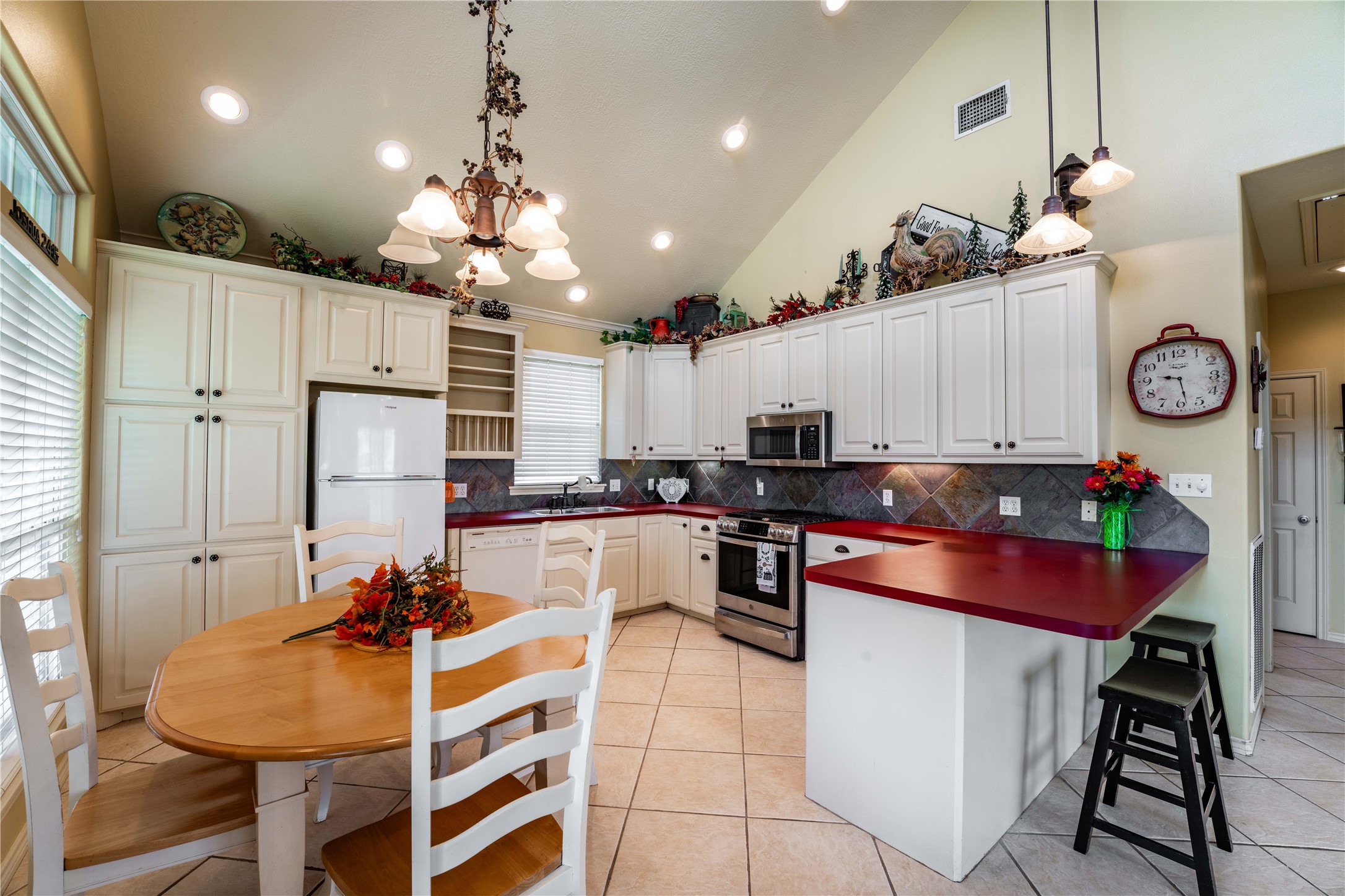 2007 FM 2434 Weimar, TX 78962 - Photo 43 of 44 a kitchen with stainless steel appliances kitchen island granite countertop a table chairs in it and wooden floors