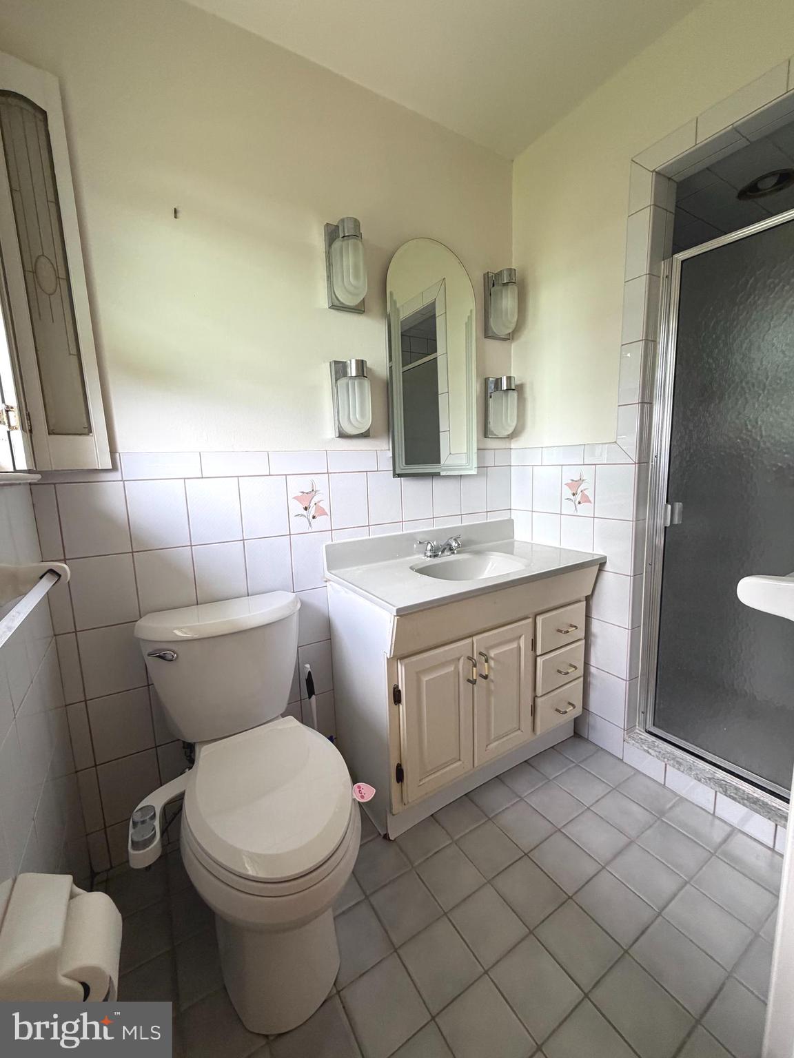 1207 Greenhill Road Flourtown, PA 19031 - Photo 5 of 9 a bathroom with a double vanity sink mirror and toilet