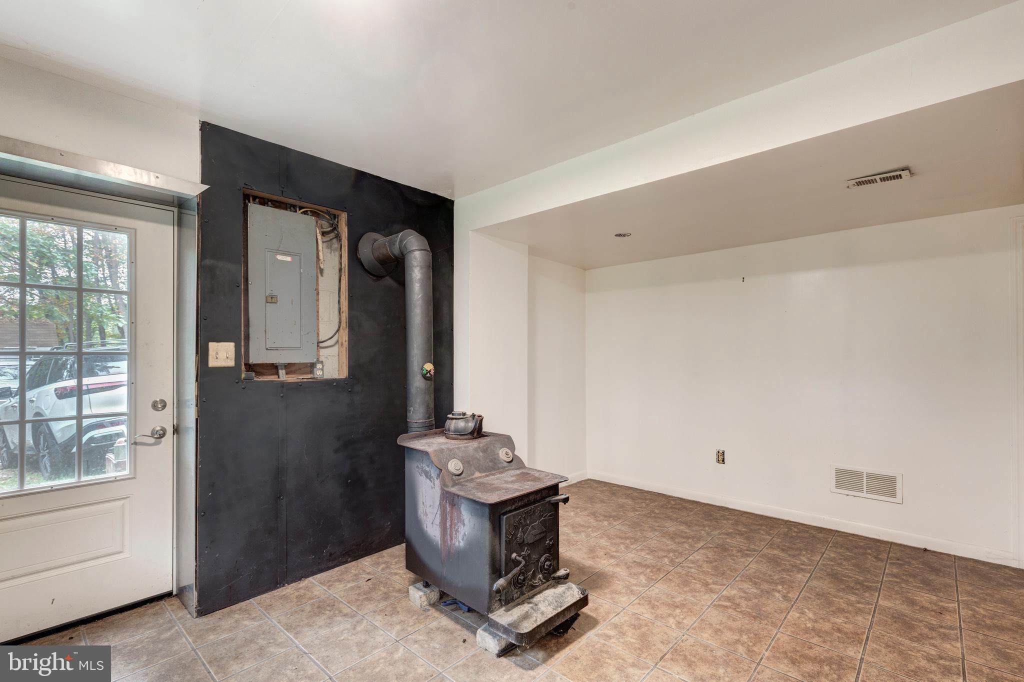 4311 York Road, Unit 1 Manchester, MD 21102 - Photo 20 of 42 a room with a fireplace and gym equipment