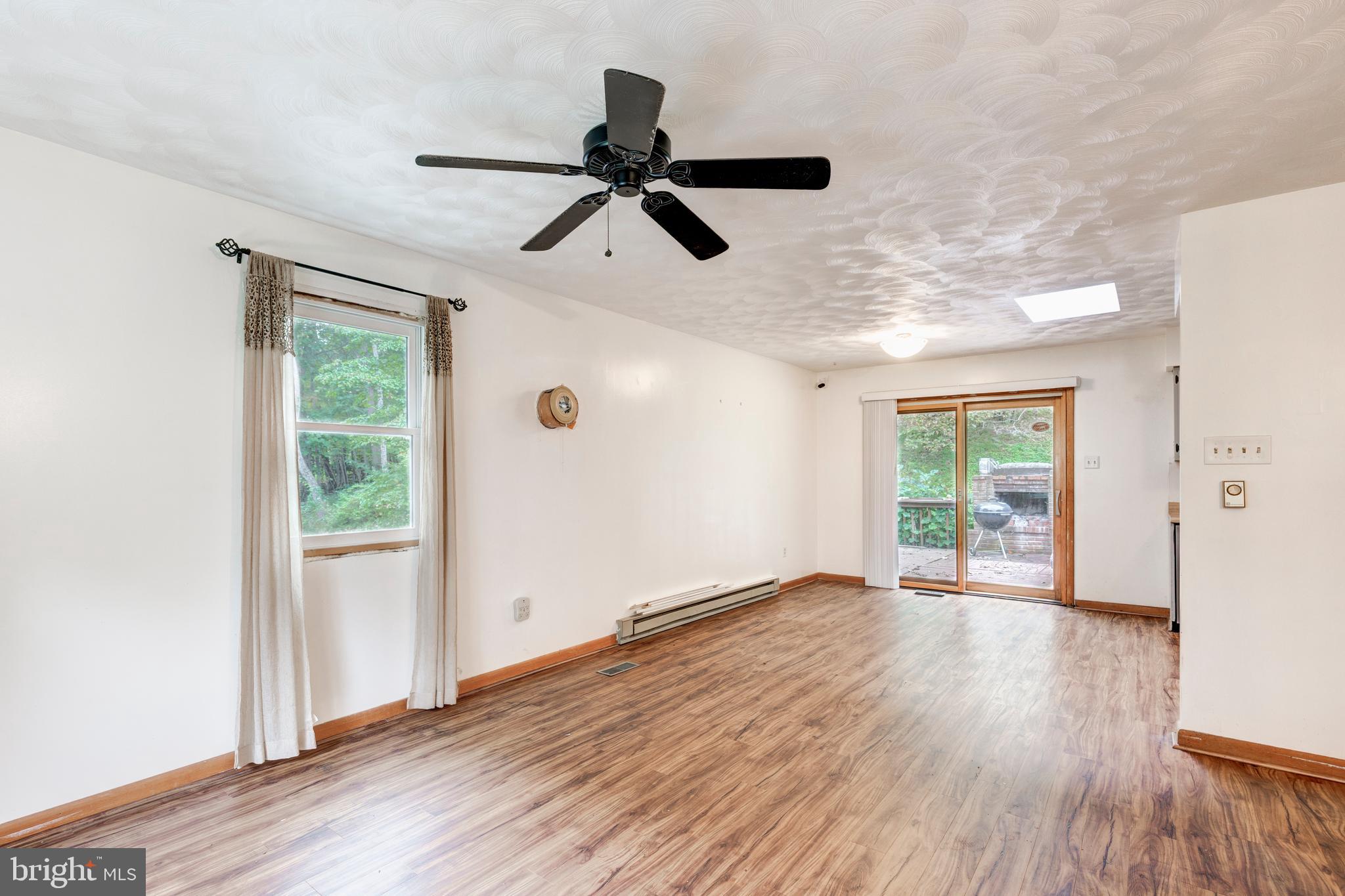 4311 York Road, Unit 1 Manchester, MD 21102 - Photo 6 of 42 a view of an empty room with wooden floor and a window