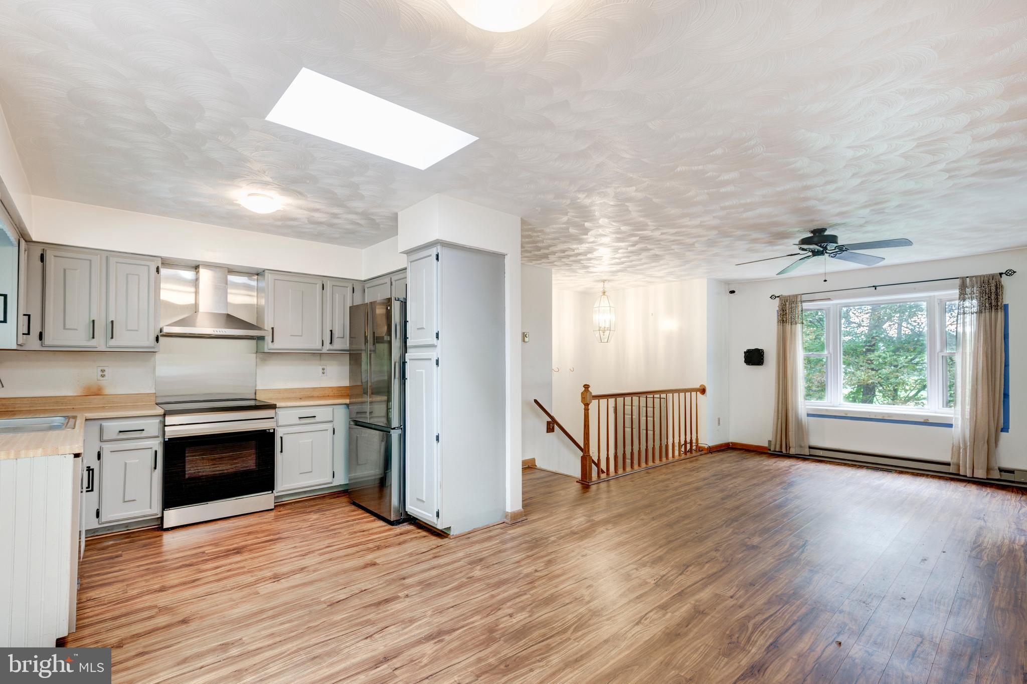 4311 York Road, Unit 1 Manchester, MD 21102 - Photo 9 of 42 a view of kitchen with stainless steel appliances granite countertop a stove top oven a refrigerator and a dishwasher with wooden floor