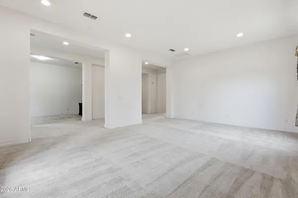 a view of an empty room with a fireplace and a large window