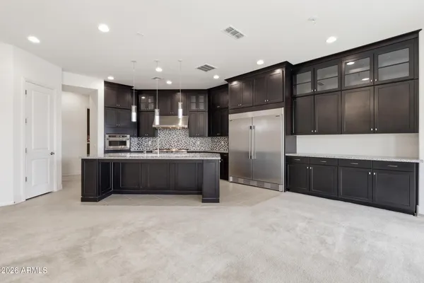 a large bathroom with a large tub a sink and a large window