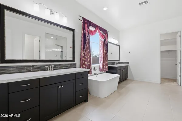 a bathroom with a double vanity sink mirror and toilet