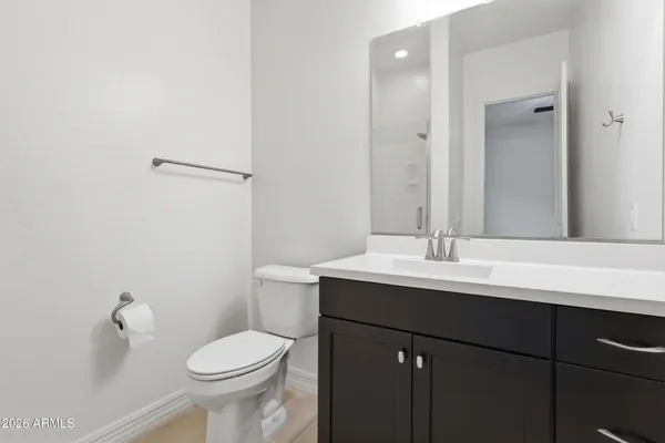 a bathroom with a sink toilet and mirror