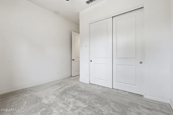 an empty room with closet area